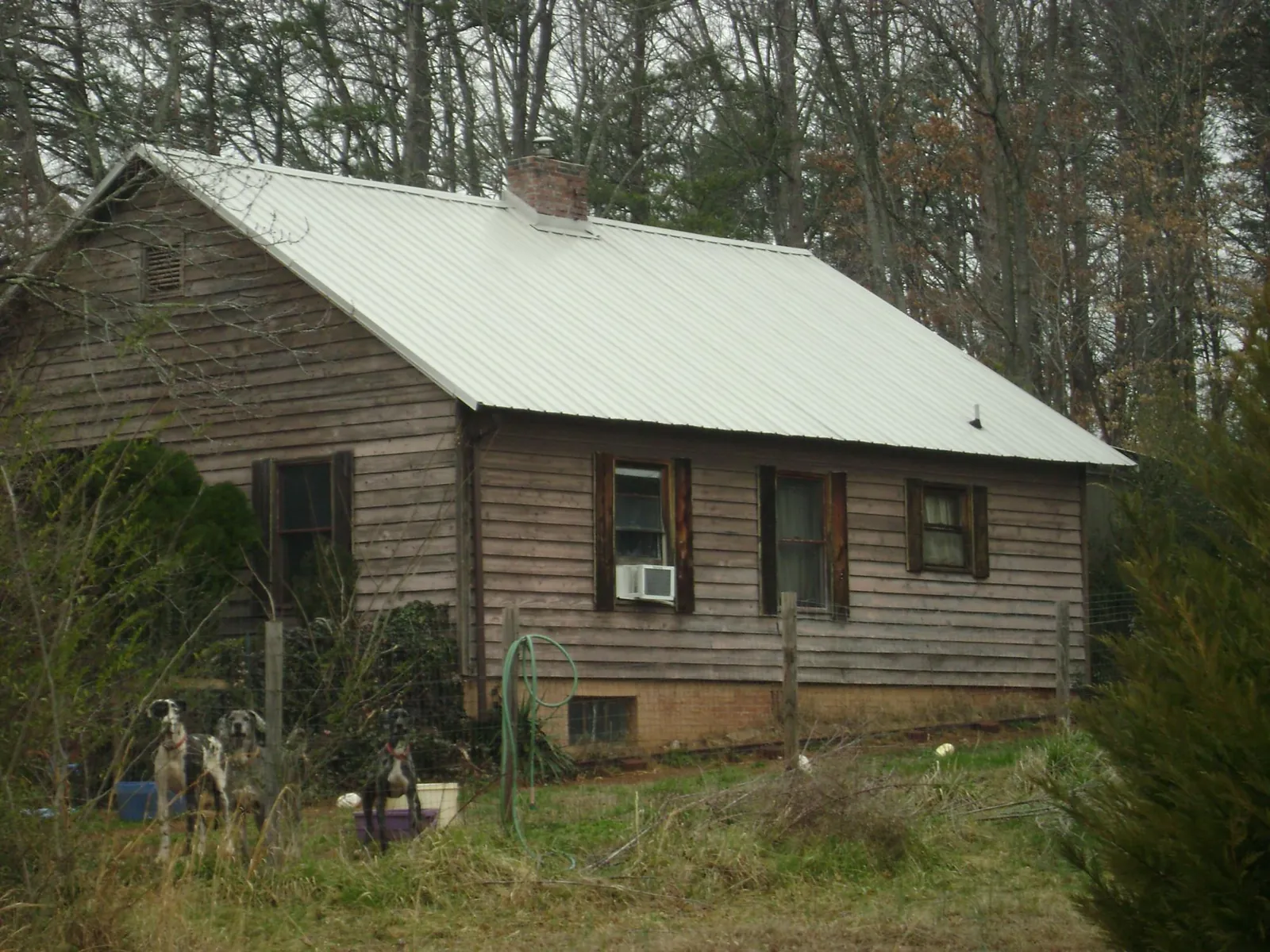 White metal roof on an old wood sided farmhouse, from a Metal Roof Installation job in Cresson